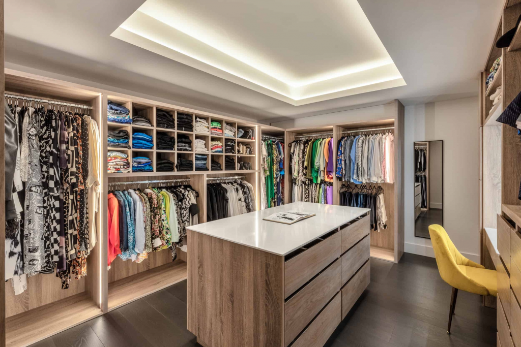 Custom Closets - Walk in with island and overhead recessed lighting