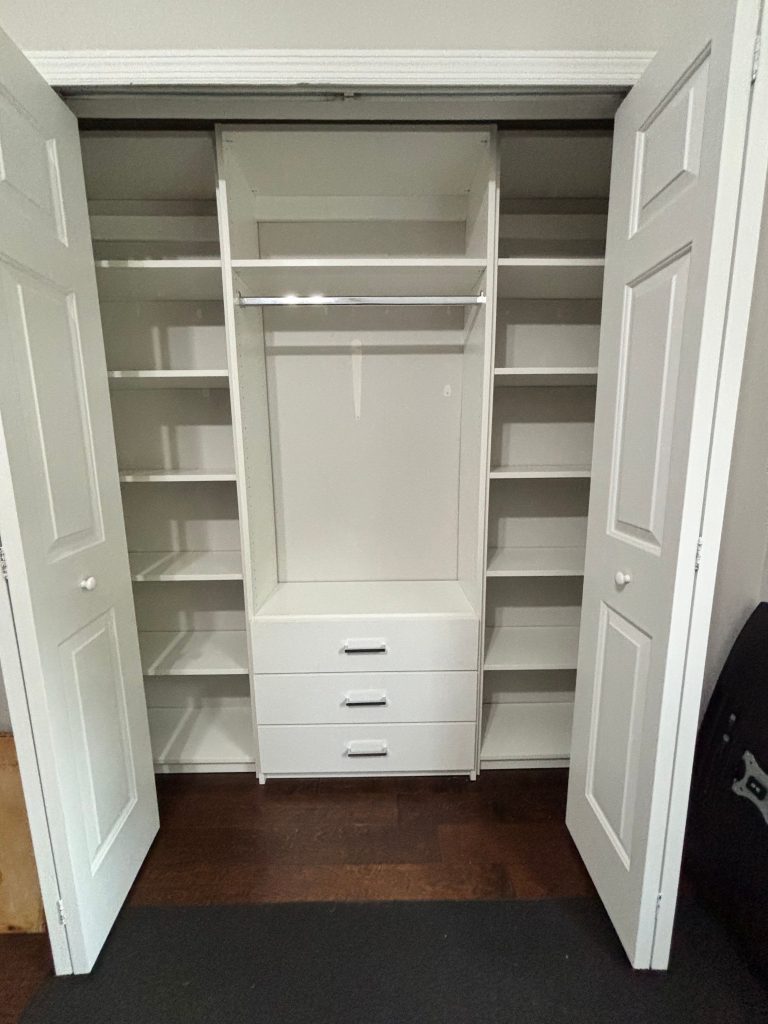 Custom reach-in closet with drawers, chrome hardware in Land O' Lakes, Florida.