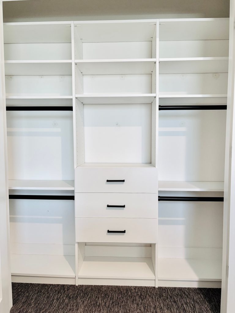 Custom reach-in closet with drawers, black hardware in Wesley Chapel, Florida.