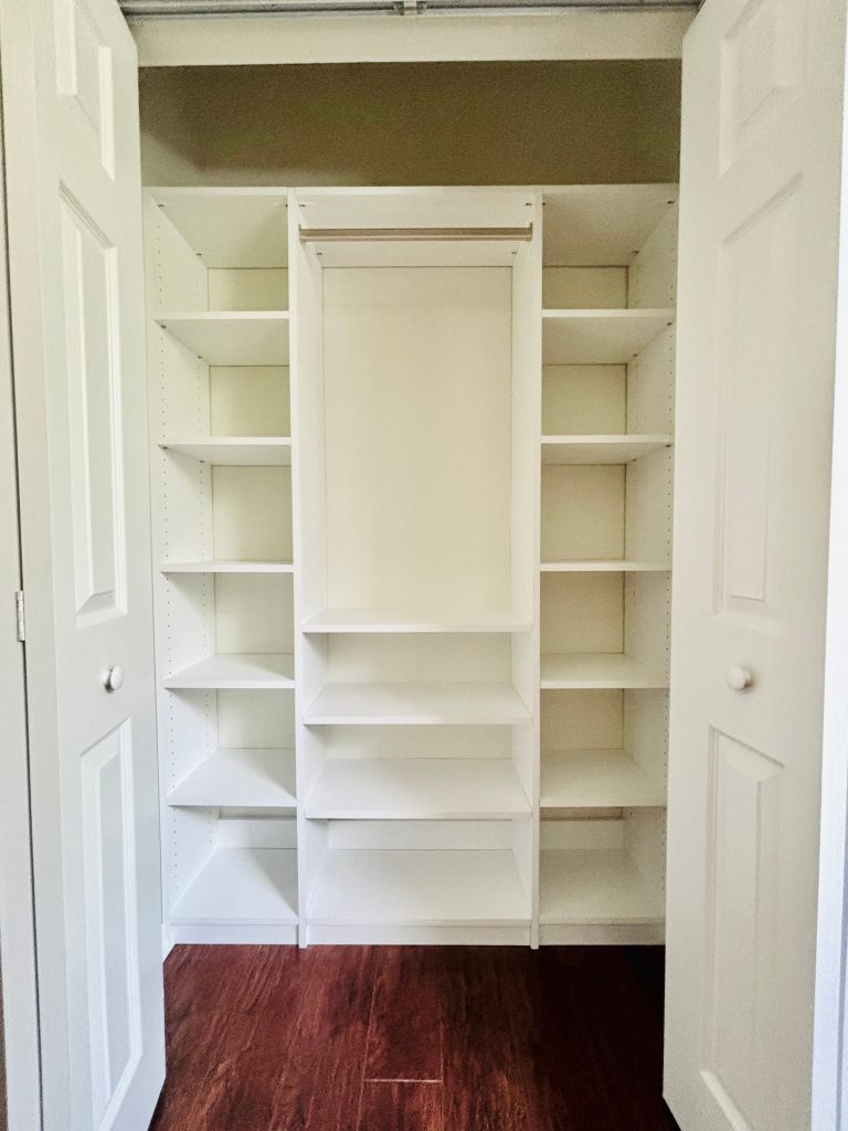 Custom reach-in closet with nickel hardware in Land O' Lakes, Florida.
