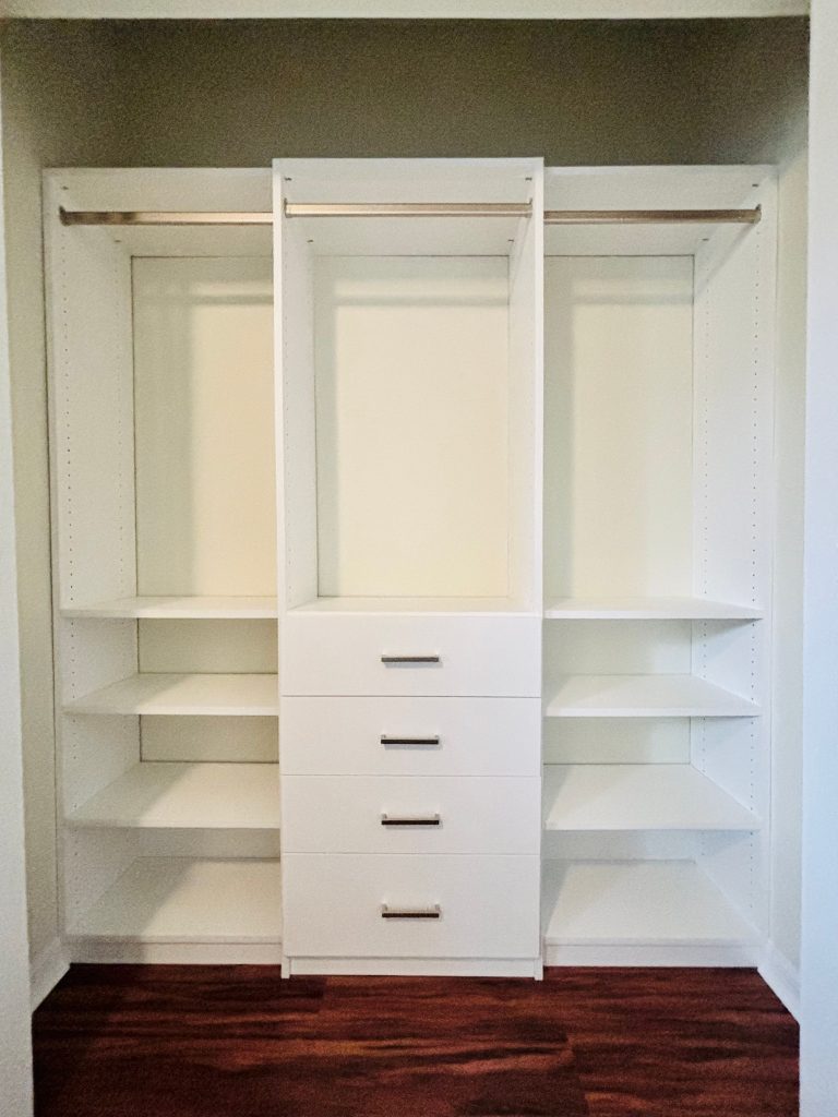 Custom reach-in closet with drawers, nickel hardware in Land O' Lakes, Florida.