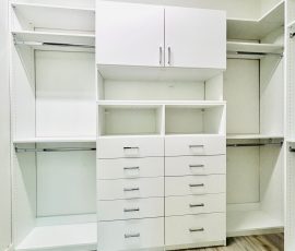 Custom walk-in closet with doors, drawers, chrome hardware in San Antonio, Florida.