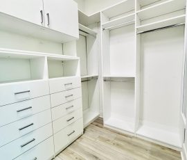 Custom walk-in closet with doors, drawers, chrome hardware in San Antonio, Florida.