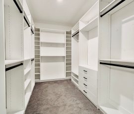 Custom walk-in closet with drawers, black hardware in Wesley Chapel, Florida.