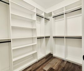 Custom walk-in closet with black hardware in Trinity, Florida.