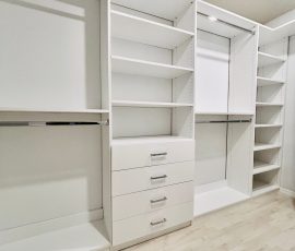 Custom walk-in closet with drawers, chrome hardware in Lithia, Florida.