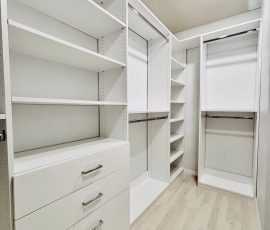 Custom walk-in closet with drawers, chrome hardware in Lithia, Florida.