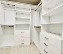 Custom walk-in closet with drawers, chrome hardware in Lithia, Florida.