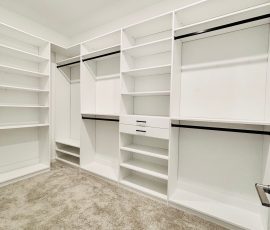 Custom walk-in closet with drawers, black hardware in San Antonio, Florida.