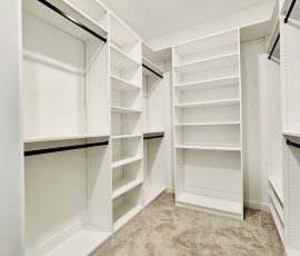 Custom walk-in closet with drawers, black hardware in San Antonio, Florida.