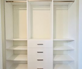 Custom reach-in closet with drawers, nickel hardware in Land O' Lakes, Florida.