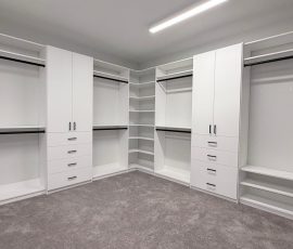 Custom walk-in closet project with doors, drawers, corner shelves, black hardware in Lithia, Florida. Custom walk-in closet with doors, drawers, corner shelves, black hardware in Lithia, Florida.