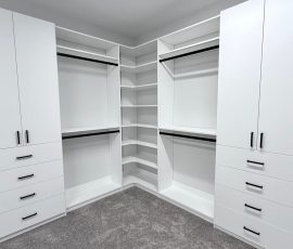 Custom walk-in closet project with doors, drawers, corner shelves, black hardware in Lithia, Florida. Custom walk-in closet with doors, drawers, corner shelves, black hardware in Lithia, Florida.