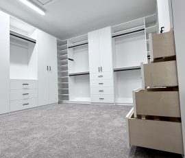 Custom walk-in closet project with doors, drawers, corner shelves, black hardware in Lithia, Florida. Custom walk-in closet with doors, drawers, corner shelves, black hardware in Lithia, Florida.