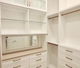 Custom walk-in closet with doors, drawers, glass, jewelry / accessory tray, matte colors, shoe fence, thermofoil, gold hardware in Zephyrhills, Florida.