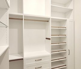 Custom walk-in closet with doors, drawers, glass, jewelry / accessory tray, matte colors, shoe fence, thermofoil, gold hardware in Zephyrhills, Florida.