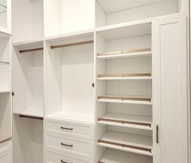 Custom walk-in closet with doors, drawers, glass, jewelry / accessory tray, matte colors, shoe fence, thermofoil, gold hardware in Zephyrhills, Florida.