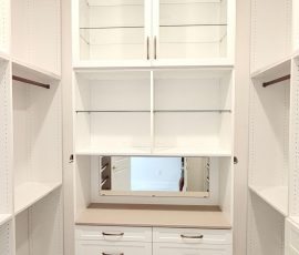 Custom walk-in closet with doors, drawers, glass, jewelry / accessory tray, matte colors, shoe fence, thermofoil, gold hardware in Zephyrhills, Florida.