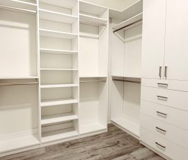 Custom walk-in closet with doors, drawers, jewelry / accessory tray, nickel hardware in Brooksville, Florida.