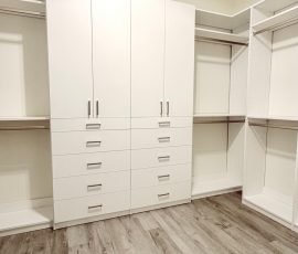 Custom walk-in closet with doors, drawers, jewelry / accessory tray, nickel hardware in Brooksville, Florida.