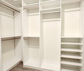 Custom walk-in closet with doors, drawers, jewelry / accessory tray, nickel hardware in Brooksville, Florida.