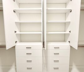 Custom walk-in closet with doors, drawers, jewelry / accessory tray, nickel hardware in Brooksville, Florida.