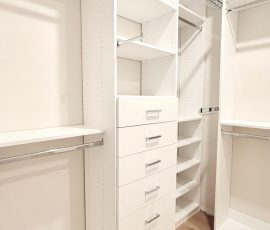 Custom walk-in closet with chrome hardware in San Antonio, Florida.