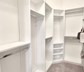 Custom walk-in closet with chrome hardware in Wesley Chapel, Florida.