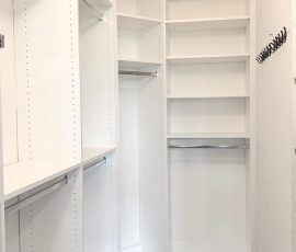 Custom walk-in closet with chrome hardware in Wesley Chapel, Florida.
