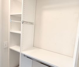 Custom walk-in closet with chrome hardware in Wesley Chapel, Florida.