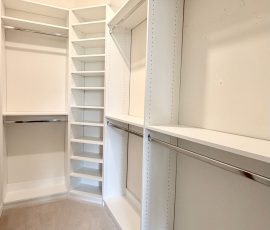 Custom walk-in closet with chrome hardware in San Antonio, Florida.